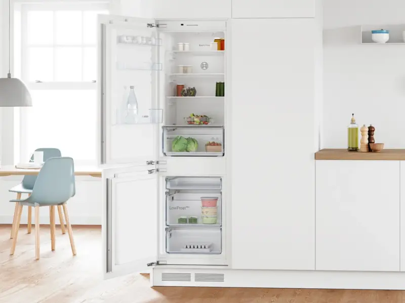 Bosch integrated fridge freezer open in a fitted kitchen