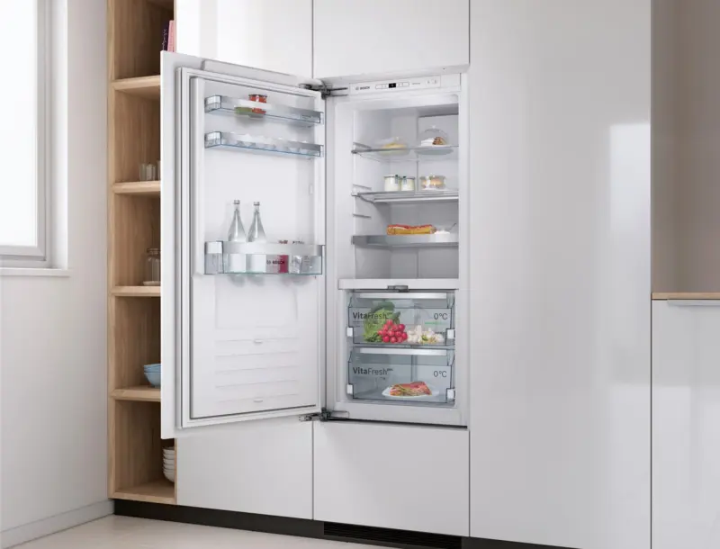 Bosch integrated fridge open in fitted kitchen cabinetry